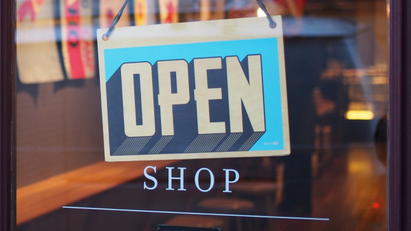 The front door of a shop with a sign that says open